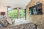 Queen sized bed upstairs with view of Bald Mountain Lake